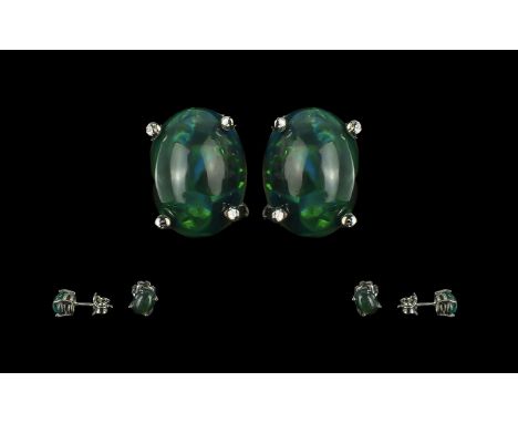 Pair of Cabochon Ethiopian Black Opal Studs in silver.  The oval cut black Opals in claw setting.