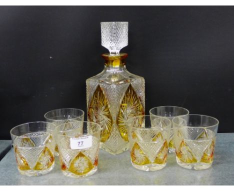 A cut crystal decanter set with amber panels comprising a square decanter and stopper and set of six tumblers 