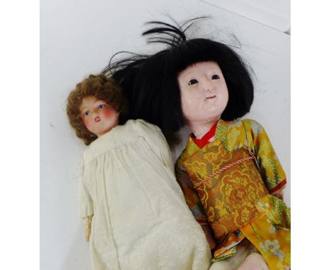 A vintage Japanese doll with bisque head and limbs, dressed in a traditional costume, together with an early 20th century bis