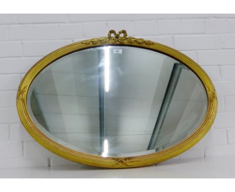 An oval gilt framed wall mirror with a bevelled plate, 85 x 60cm