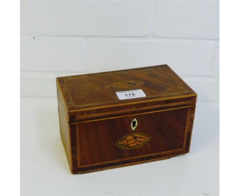 A mahogany and inlaid tea caddy with shell paterae to the lid and front with a lead lined interior, 18 x 10cm 