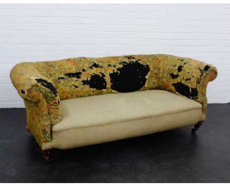 An early 20th century two seater sofa with scroll arms and turned mahogany supports and brass caps, 74 x 144cm