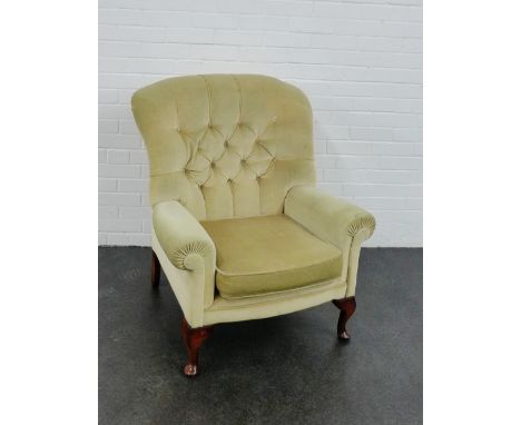 An upholstered button back armchair on cabriole supports 