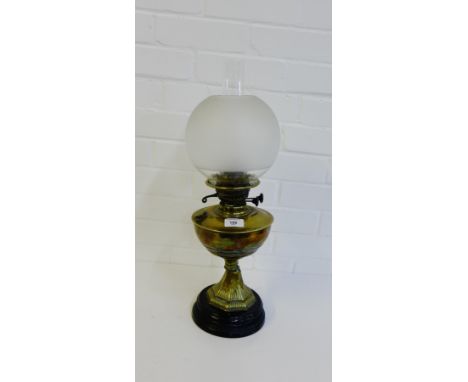 A brass oil lamp on circular hardstone base 