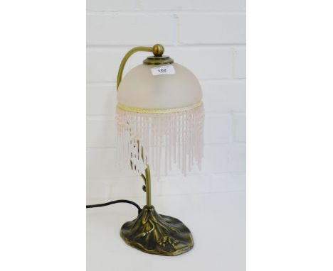 An Art Nouveau style table lamp with opaque pink glass shade, 37cm high