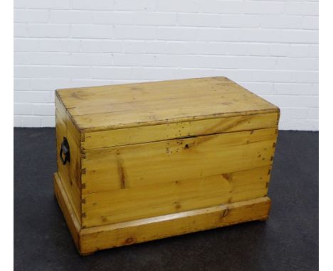 A pine storage trunk, with iron handles to side and plinth base,  50 x 80cm