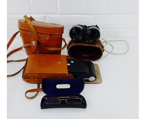 A pair of Hezzanith binoculars, together with Boots 8 x 30 binoculars. a Kodak 620 camera and a pair of vintage spectacles, (