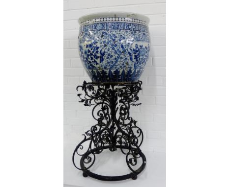 A large Chinese blue and white planter with all over prunus pattern and birds, figures and stylised borders, with staple repa