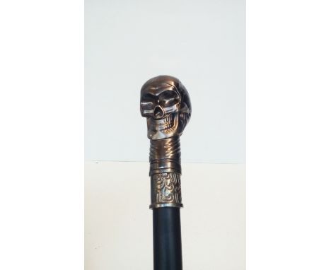 Walking stick with stylised skull finial 