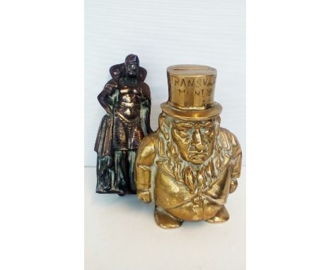 Transvaal brass money box together with a brass door knocker in the form of a soldier, both 14cm in height  