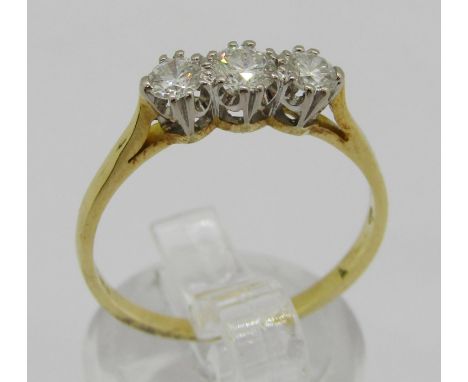 18ct three stone diamond ring, centre stone 0.20ct approx, outer stones 0.15ct each approx, London 2007, size Q, 2.4g 