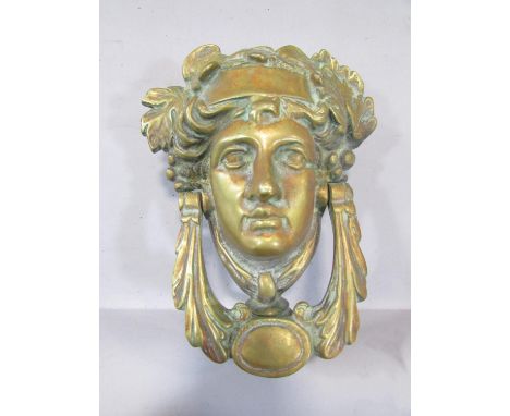 A brass French Empire style Baccanalian female mask door knocker, with screw fastenings, 18cm. 