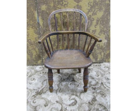 A 19th century Windsor comb back child's armchair, 60 cm high x 45 cm wide 