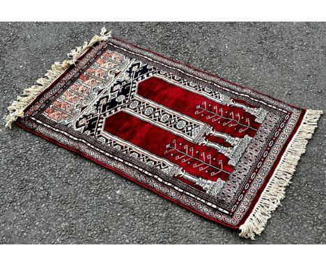 A small silk prayer mat, a small Bokhara rug with a single row of guls, a small Bokhara with two rows and a fourth similar. (