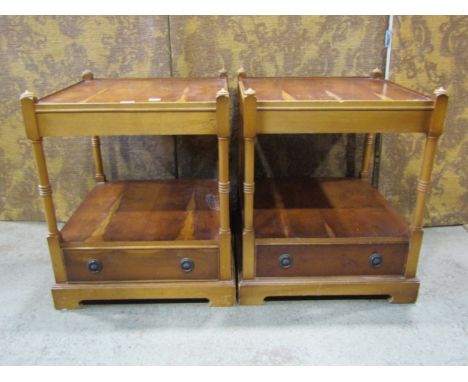 A pair of reproduction yew wood veneered two-tier low lamp or bedside tables, 56cm high, 46 x 46cm. 