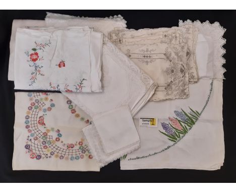 A boxful of vintage table linen including cloths with colourful floral embroidery, others with lace and crochet edging etc 