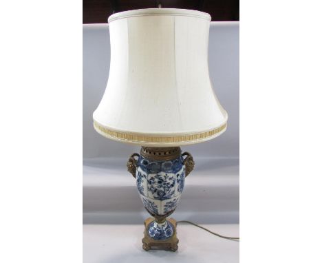 A 19th century style blue and white crackle glazed lamp with gold satyre masks with a shade, 57cm high approx. together with 