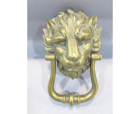 A brass lion mask door knocker, with screw fastenings, 24cm. 