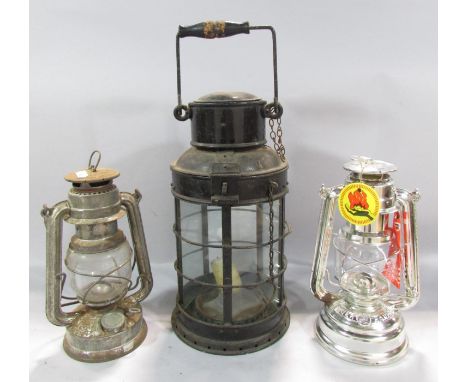 A 19th century metal five glass panel storm lamp with a single candle holder, a later oil Hurricane lamp and an as new  Feuer