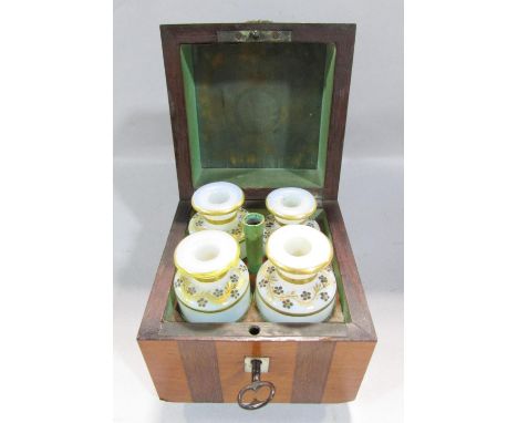 A 19th century continental scent bottle box with a ring handle opening to reveal four opaque scent bottles with gilded floral