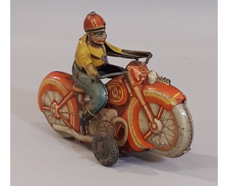 A vintage clockwork  tin plate motorcycle and rider, made in West Germany. Length 16cm 