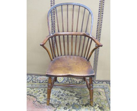 A Georgian Windsor comb back chair in elm and ash 