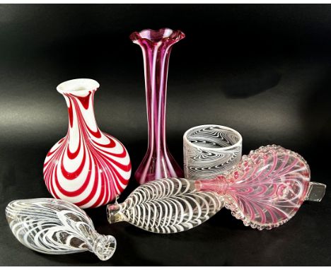 A collection of 19th century Nailsea glassware, including a pink candy stripe bellows, two flats bottle and a beaker, a pink 