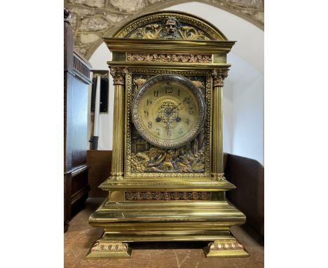 A large 19th century French brass cased bracket clock, the architectural casework decorated with gilt metal panels depicting 