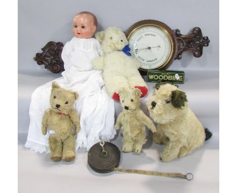 A miscellaneous collection of items including an early 20th century bisque head doll, three vintage mohair teddy bears, and a