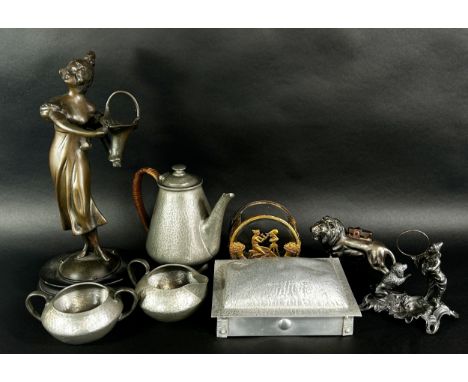 A Tudric Pewter three piece tea service, a muffin dish, a bronzed lion table lighter, a performing clown with a loop leaping 