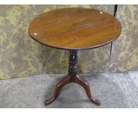 A 19th century oak snap top occasional table of circular form raised on a ring turned pillar and swept tripod, 72 cm diameter