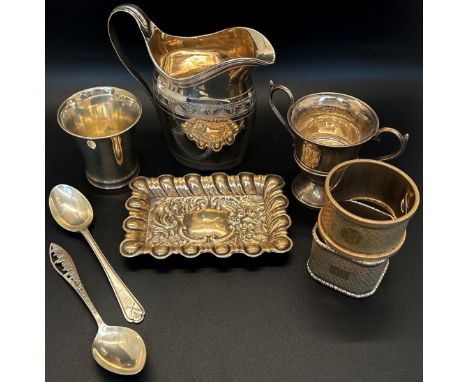 A mixed selection of silver including a cream jug, two napkin rings, a beaker, dish, a twin handled trophy, a New York city s