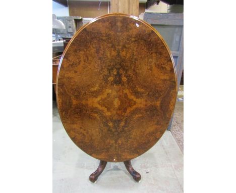 A Victorian loo table with quarter veneered burr walnut top, raised on a four pillar base with scrolled supports, 135cm max 