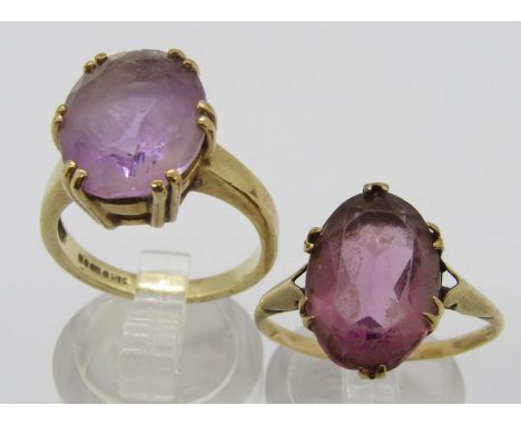9ct claw set oval pale amethyst dress ring, together with a further 9ct example set with amethyst coloured paste, both size P