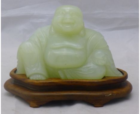 A carved jade model of Buddha, on stand