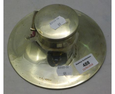 A silver capstan inkwell