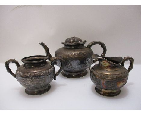 An early 20th century Chinese three piece silver tea service of boulbous form, embossed with flowers and a bird on a branch, 