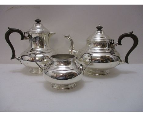 A silver teapot, coffee pot and sugar bowl of baluster form having composition handles and knop finials by Thomas Bradbury & 