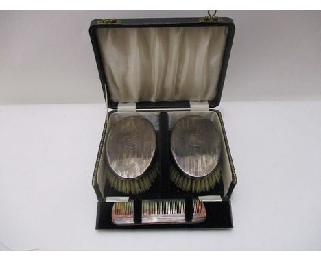 A pair of Edward VIII hair brushes and comb by Robert Pringle & Sons, Birmingham 1936 with engine turned decoration, cased