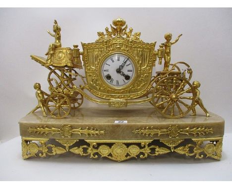 A late 19th century French gilt metal cased mantle clock having a foliate and grape design on a marble base, standing on eigh
