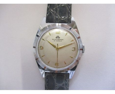 A gents chrome plated Bucherer wristwatch, circa 1950. The signed, silvered dial with gilt baton/Arabic numerals and gilt han