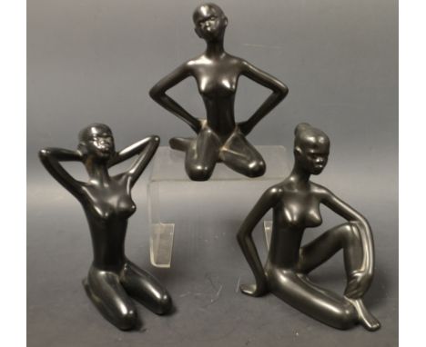 A set of three ceramic figures, tribal females, glazed throughout in black