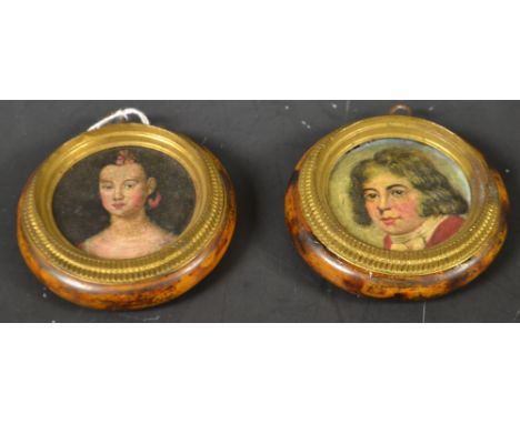 A pair of circular portrait miniatures, framed 