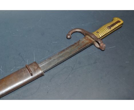 A French bayonet, brass grip, steel blade, the scabbard numbered J 5322