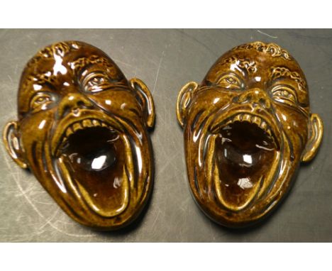A pair of grotesque mask head pipe racks (converted to wall masks, impressed 13 verso) (2)