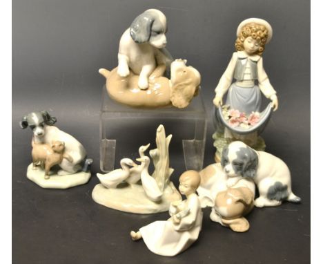 A Nao Spanish porcelain figure of a little girl; similar Nao puppy models; others (6)