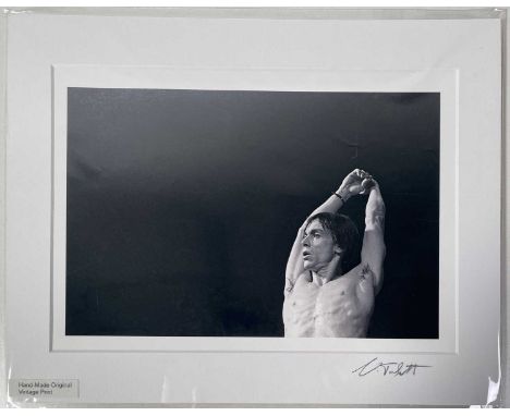 An A4 mounted digital print, scanned from the original negative and printed onto Canon pro-paper. Depicts Iggy Pop onstage at