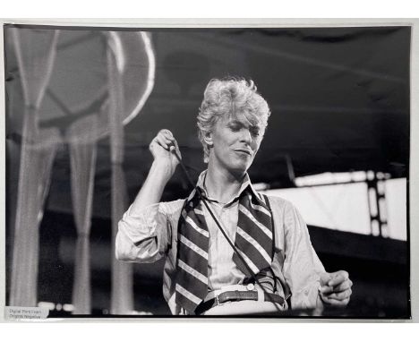 An original A3 photo print (16.5x12") depicting David Bowie onstage at Milton Keynes Bowl during the Serious Moonlight tour, 