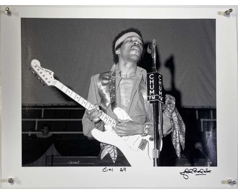 A high-quality photo print of a photograph by John Rowlands depicting Jimi Hendrix onstage in Toronto, 1969. Signed and title