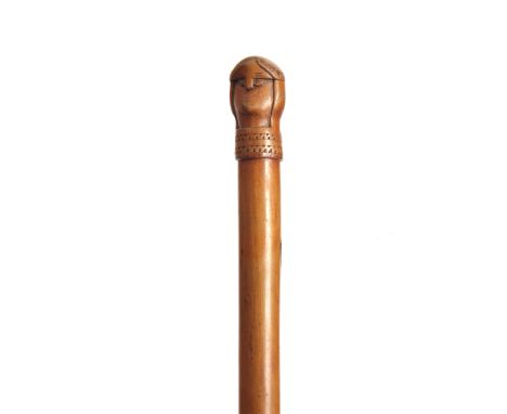 AN EARLY 20TH CENTURY SCANDINAVIAN HARDWOOD WALKING STICK carved with a two-faced figural handle possibly a Viking - 90cm lon